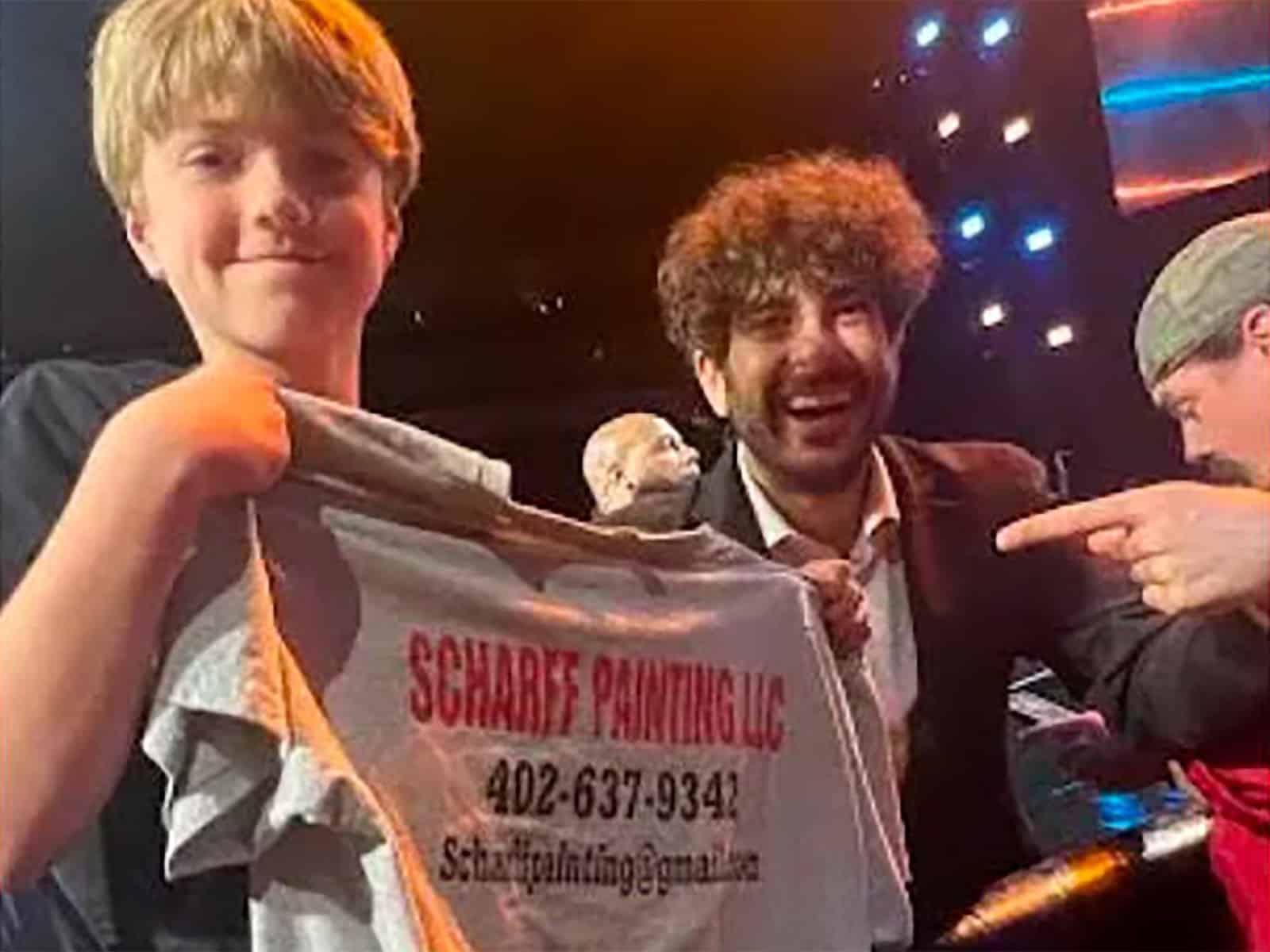 Local public figure posing with Scharff Painting team during a community event in Omaha